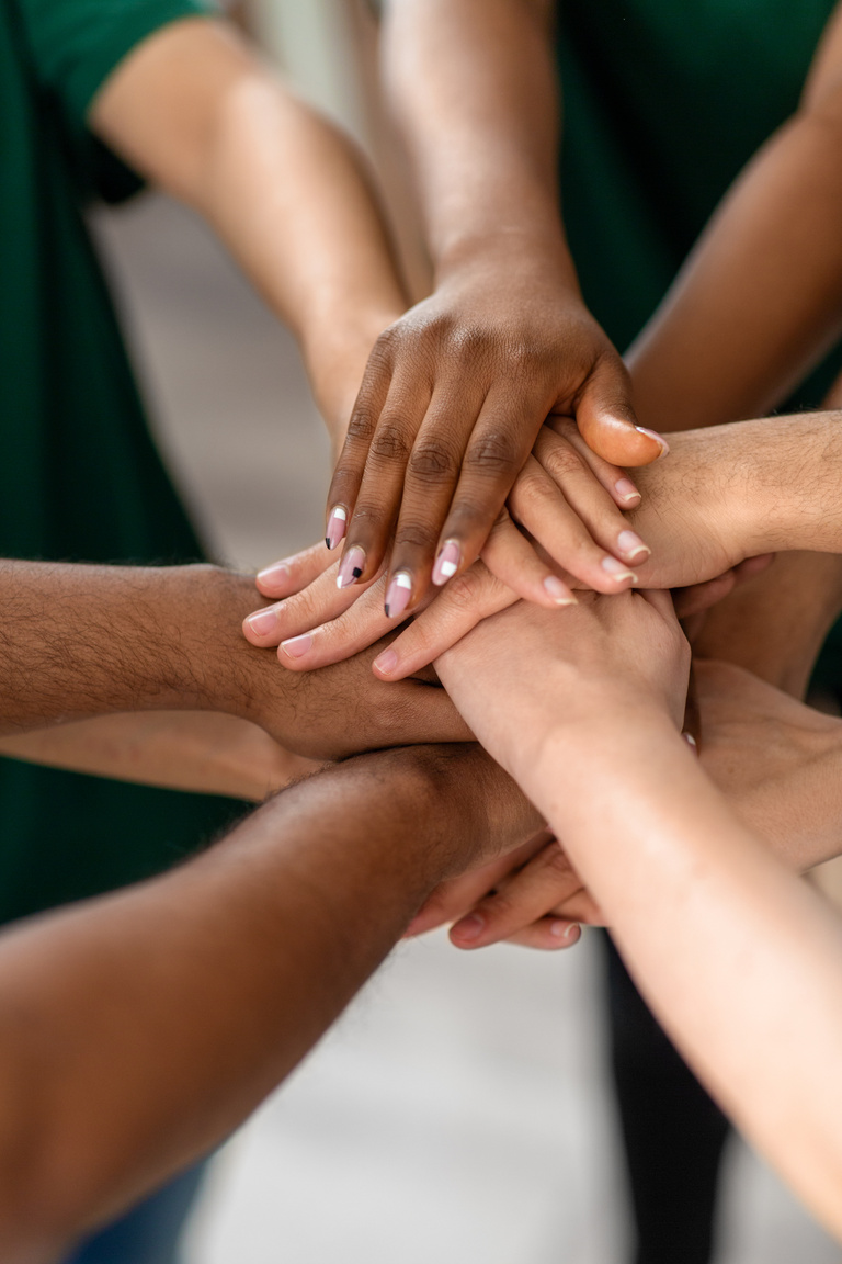 Close up of Volunteers Stacking Hands